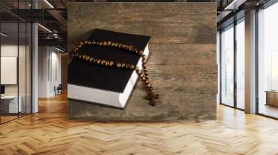 Bible with rosary on old wooden background with copy space Wall mural