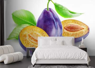 Composition of whole and cut in two halves plums with leaves isolated on white background. Wall mural