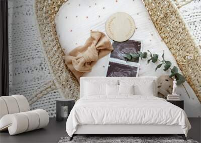 Flat lay composition with cute baby items in basket. The concept of awaiting baby, pregnancy Wall mural