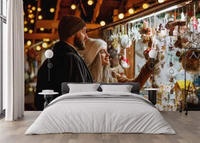 christmas, winter holidays, vacation, travel, purchase conception: happy smiling couple shopping at  Wall mural