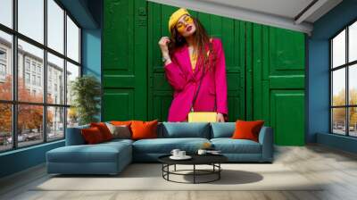 fashionable confident woman wearing trendy outfit with yellow sunglasses, beret, wrist watch, should Wall mural