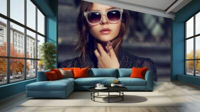 outdoor close up portrait of young beautiful fashionable girl posing in street. model wearing stylis Wall mural