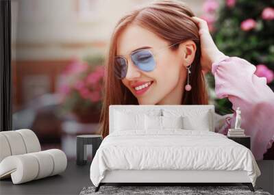 outdoor close up portrait of young beautiful happy smiling woman wearing blue aviator sunglasses, tr Wall mural