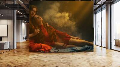 Studio art portrait of two beautiful redhead freckled women wearing red dresses posing in smoke, darkness and warm light. Copy, empty space for text Wall mural