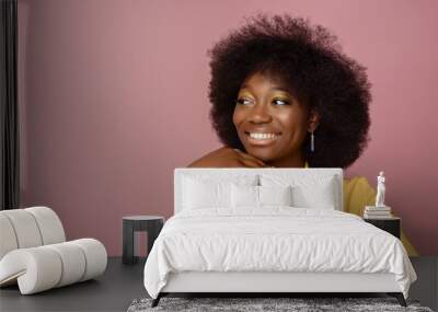 Yong beautiful happy smiling African American woman, model wearing elegant jewelry, yellow blazer, posing in studio, on pink background. Girl looking aside. Copy, empty space for text
 Wall mural