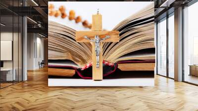 Bible with wooden cover and wooden rosary on white background Wall mural