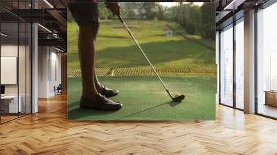 Low angle of man golfing at driving range Wall mural