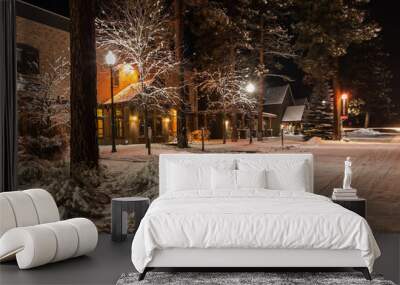 Small town winter street covered by fresh snow and illuminated at night Wall mural