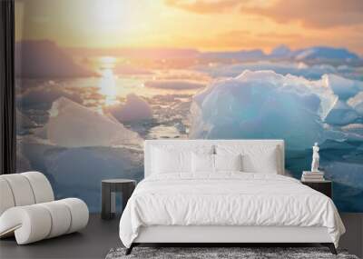 The setting sun bathes the ice floes in a soft, golden light, creating a scene of serene beauty Wall mural