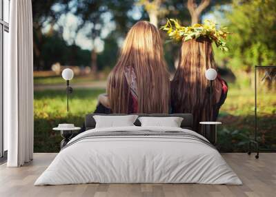 Two teenager girls sitting outside. Friendship concept  Wall mural