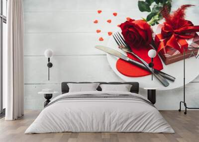 Valentines day table setting with plate, fork, knife, ribbon and rose. background Wall mural