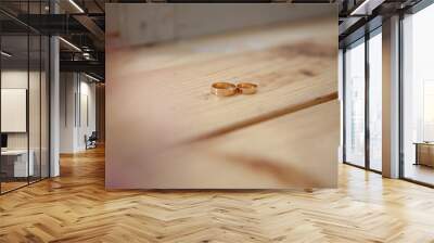 wedding rings on a wooden table background Wall mural