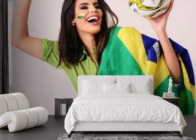 brazilian girl celebrating with flag and ball Wall mural