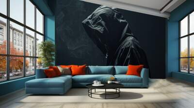 Silhouette of a person wearing a dark hoodie, creating a mysterious and ominous atmosphere with smoke in the background. Wall mural