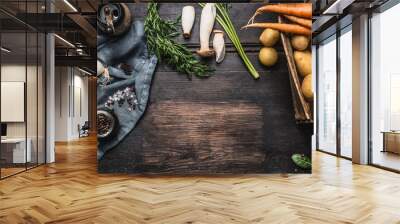 Autumn seasonal cooking ingredients with harvest vegetables, greens , Potatoes and mushrooms on dark rustic wooden background, top view, place for text, border Wall mural