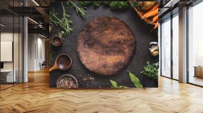 Food cooking and healthy eating background with round wooden cutting board and fresh seasoning, spoon and vegetables, top view, frame. Copy space for your text and design Wall mural