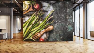 Green asparagus cooking preparation with cooking spoon and ingredients on rustic background, top view, place for text Wall mural