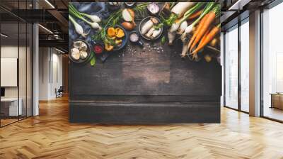 Organic harvest Vegetables from garden and  forest mushrooms. Vegetarian ingredients  for cooking on dark rustic wooden background, top view, border Wall mural