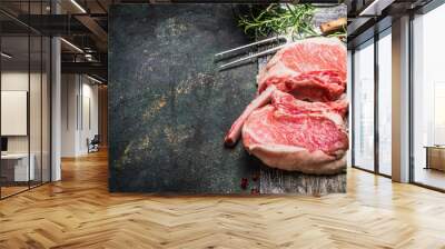 raw gourmet pork cutlet for grill, barbecue or cooking with herbs ,spices and meat fork on dark rust Wall mural