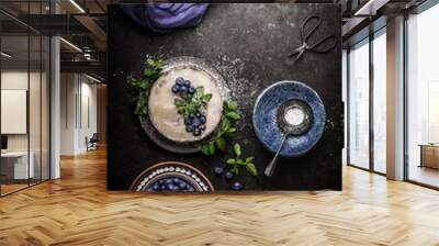 Top view of vegan no bake blueberry cake on dark rustic kitchen table background with fresh berries, side view. Healthy food Wall mural