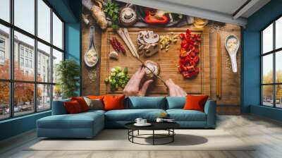 Vegetarian stir fry cooking preparation. Women female hands cut vegetables for stir fry on kitchen table background with ingredients, top view. Asian food , Chinese or Thai cuisine concept Wall mural