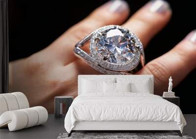 A close-up image showcasing a luxury diamond ring on a hand, featuring an intricate silver band design. The brilliance of the large gemstone is highlighted against a soft focus background, emphasizing Wall mural