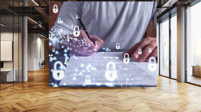 A businessman in casual wear signing the contract to prevent probability of risks in cyber security. Padlock Hologram icons over the working desk. Wall mural