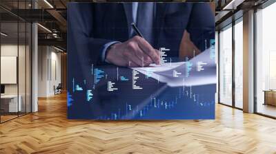 A client in formal wear is signing the contract to invest money in stock market. Internet trading and wealth management concept. Forex and financial hologram chart over the desk. Wall mural