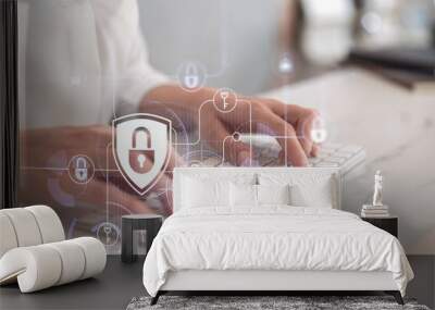 A woman programmer is typing a code on computer to protect a cyber security from hacker attacks and save clients confidential data. Padlock Hologram icons over the typing hands. Formal wear. Wall mural