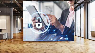 Businessman in suit checking cyber security using tablet device to protect clients confidential information. IT hologram lock icons over modern panoramic office background. Wall mural