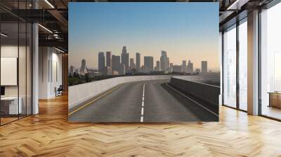 Empty urban asphalt road exterior with city buildings background. New modern highway concrete construction. Concept of way to success. Transportation logistic industry fast delivery. Los Angeles. USA. Wall mural