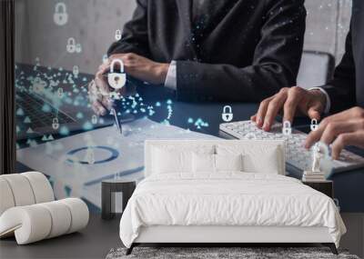 Two businesspeople man and woman working on the project to protect cyber security of international company. Padlock Hologram icons over the table with documents. Formal wear. Workspace. Wall mural