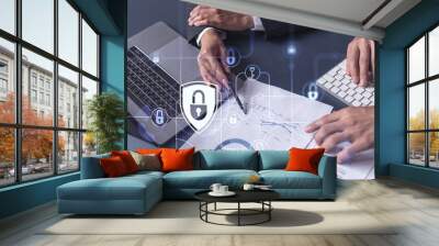 Two businesspeople man and woman working on the project to protect cyber security of international company. Padlock Hologram icons over the table with documents. Formal wear. Workspace. Wall mural