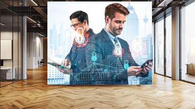 Two handsome businessman in suits working on project to protect clients confidential information at cybersecurity compliance division. IT lock icons over Kuala Lumpur background. Wall mural