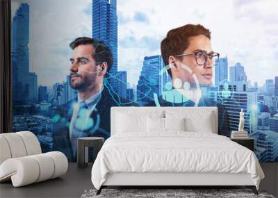 Two handsome young SMM specialists thinking about development of social media marketing strategy to achieve business goals. Hologram icons over Bangkok background. Wall mural