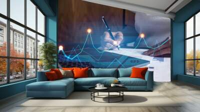 Woman signs agreement. Financial market chart and graph hologram. Double exposure . Business Analysis concept. Wall mural