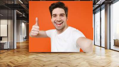 close up of cheerful funny young man 20s wearing basic casual empty blank white t-shirt doing selfie Wall mural