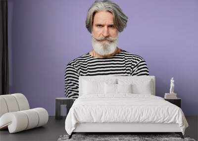 Elderly strict serious gray-haired mustache bearded man 50s in striped turtleneck hold hands crossed folded isolated on plain pastel light purple background studio portrait. People lifestyle concept. Wall mural