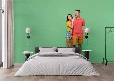 Full body smiling happy cool young couple two friends family man woman wear basic t-shirt together look aside on workspace area mock up isolated on pastel plain light green background studio portrait Wall mural