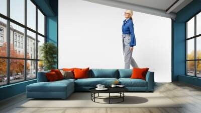 Full length side view blonde pensive happy successful employee business woman 40s in blue classic shirt gray pants glasses formal clothes walking going isolated on white background studio portrait. Wall mural