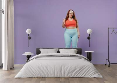 Full length young fun chubby overweight plus size big fat fit woman wear red top warm up training show thumb up gesture isolated on purple background studio home gym. Workout sport motivation concept. Wall mural