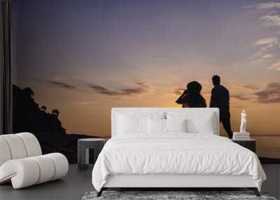 Full size back view silhouette young couple two friends family man woman in casual clothes hold hands walk stroll together at sunrise over sea beach ocean outdoor exotic seaside in summer day evening. Wall mural