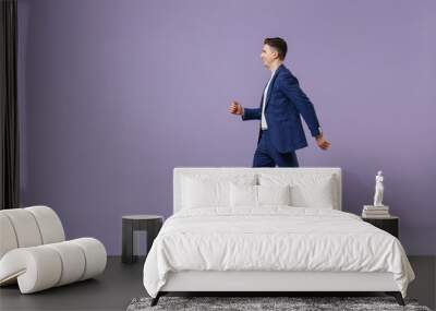 Full size body length side view young successful employee business man lawyer 20s wears formal blue suit white t-shirt work in office move stroll isolated on pastel purple background studio portrait. Wall mural