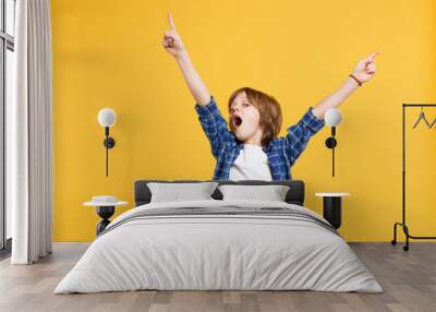 Fun cheerful happy little kid boy in blue shirt white t-shirt posing gesturing hands isolated on yellow wall background children studio portrait. People childhood lifestyle concept. Mock up copy space Wall mural