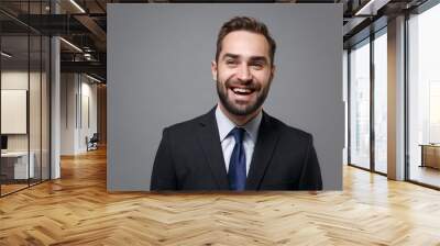 Laughing young bearded business man in classic black suit shirt tie posing isolated on grey background studio portrait. Achievement career wealth business concept. Mock up copy space. Looking aside. Wall mural