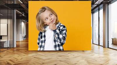 Little cute fun happy blond long-haired kid boy 5 years old wearing casual clothes posing isolated on bright yellow wall color background children studio portrait. People childhood lifestyle concept Wall mural