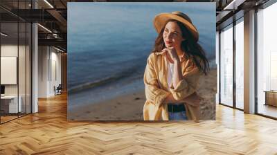 Pensive dreamful tourist traveler young happy woman 20s in straw hat shirt summer casual clothes rest outdoor at sunrise sun dawn over sea beach background People vacation lifestyle journey concept Wall mural