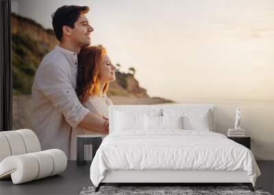 Profile happy romantic satisfied smiling young couple two friends family man woman 20s in white clothes hug rest together at sunrise over sea beach ocean outdoor seaside in summer day sunset evening Wall mural