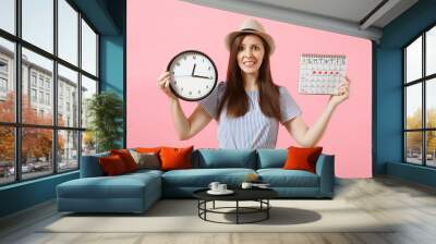 Shocked confused sad woman in blue dress holding round clock, periods calendar for checking menstruation days isolated on trending pink background. Medical healthcare gynecological concept. Copy space Wall mural