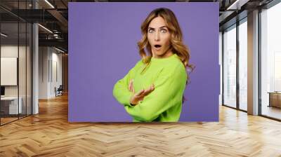 Side view young shocked surprised sad woman 30s she wearing casual green knitted sweater hold hands crossed folded isolated on plain pastel purple background studio portrait People lifestyle concept Wall mural